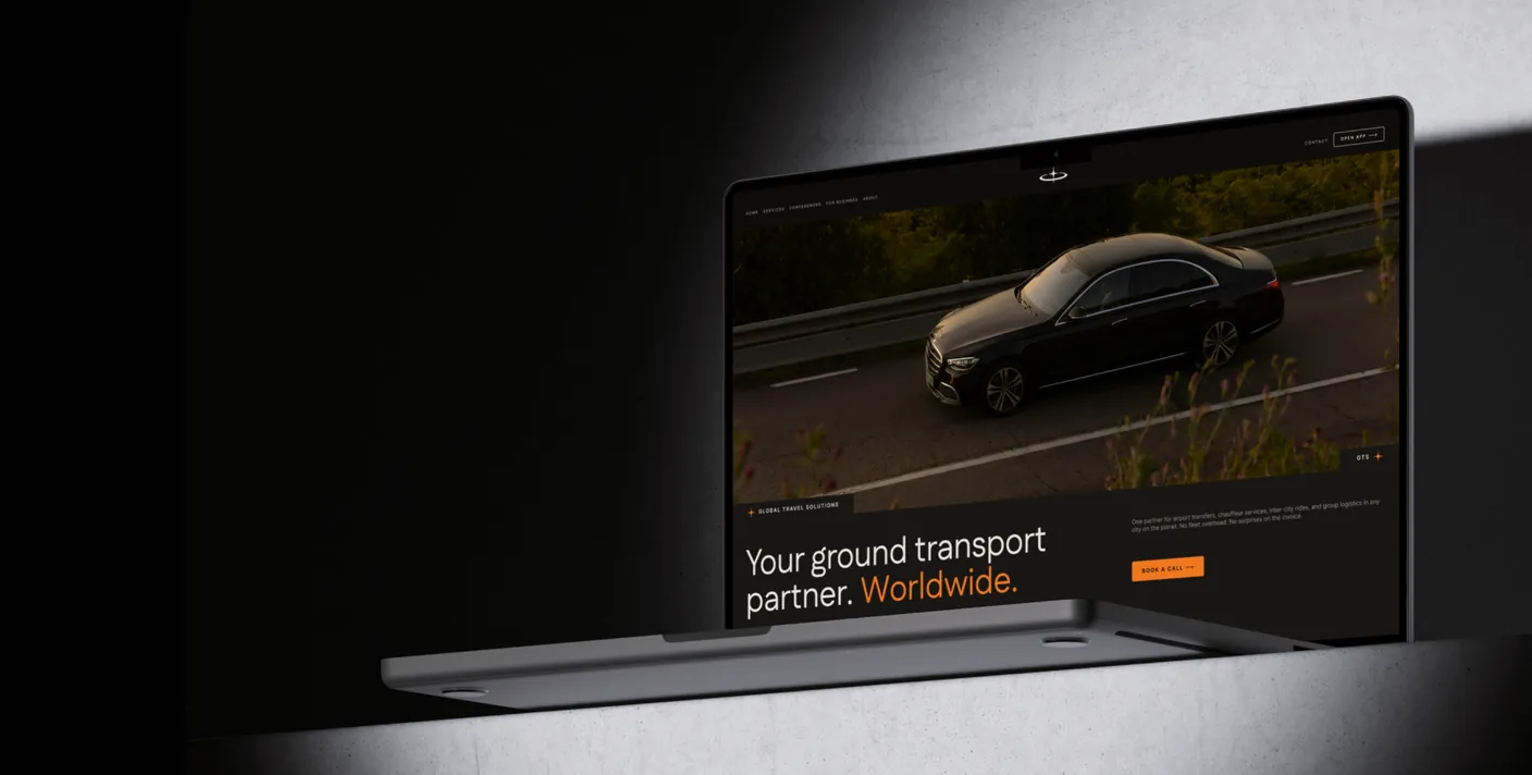 The Global Travel Solutions website on a MacBook — a black S-class on the open road under the headline “Your ground transport partner. Worldwide.”