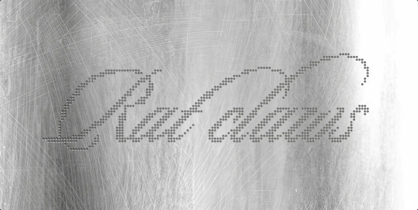 The Rat claws logotype debossed as a dotted script into brushed metal