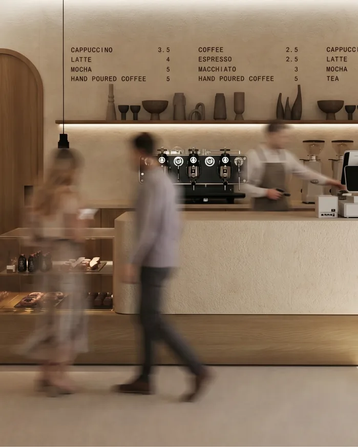 Sage café counter with a barista and menu board